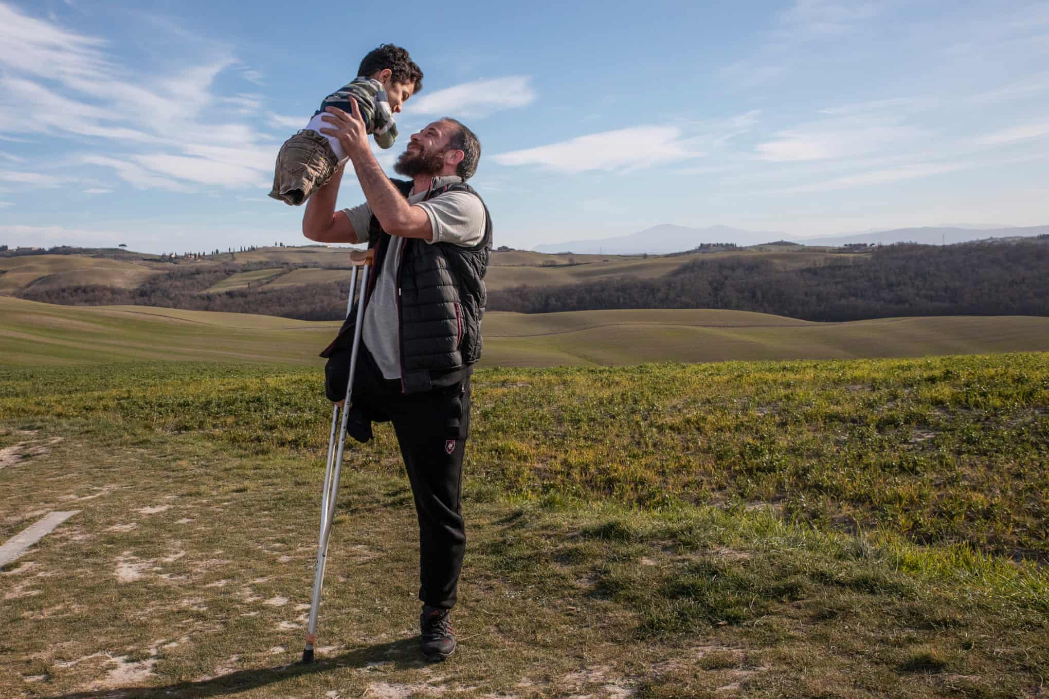 Flying high: how a photo of a Syrian father and son led to a new life in Italy 1